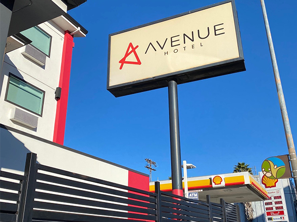 Avenue Hotel sign stands prominently, symbolizing accessible housing options for individuals experiencing homelessness.