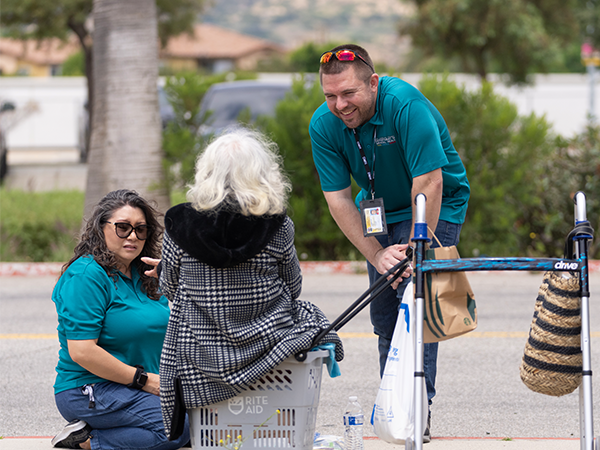Members of the Department of Mental Health talk with a woman experiencing homelessness.