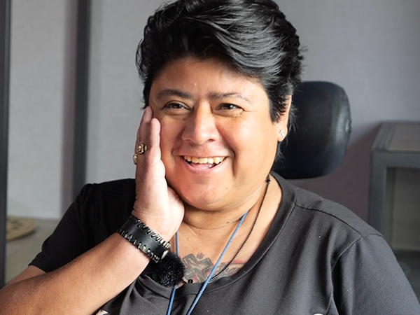 Maria smiles at the camera in her new room at Homekey: Avenida.