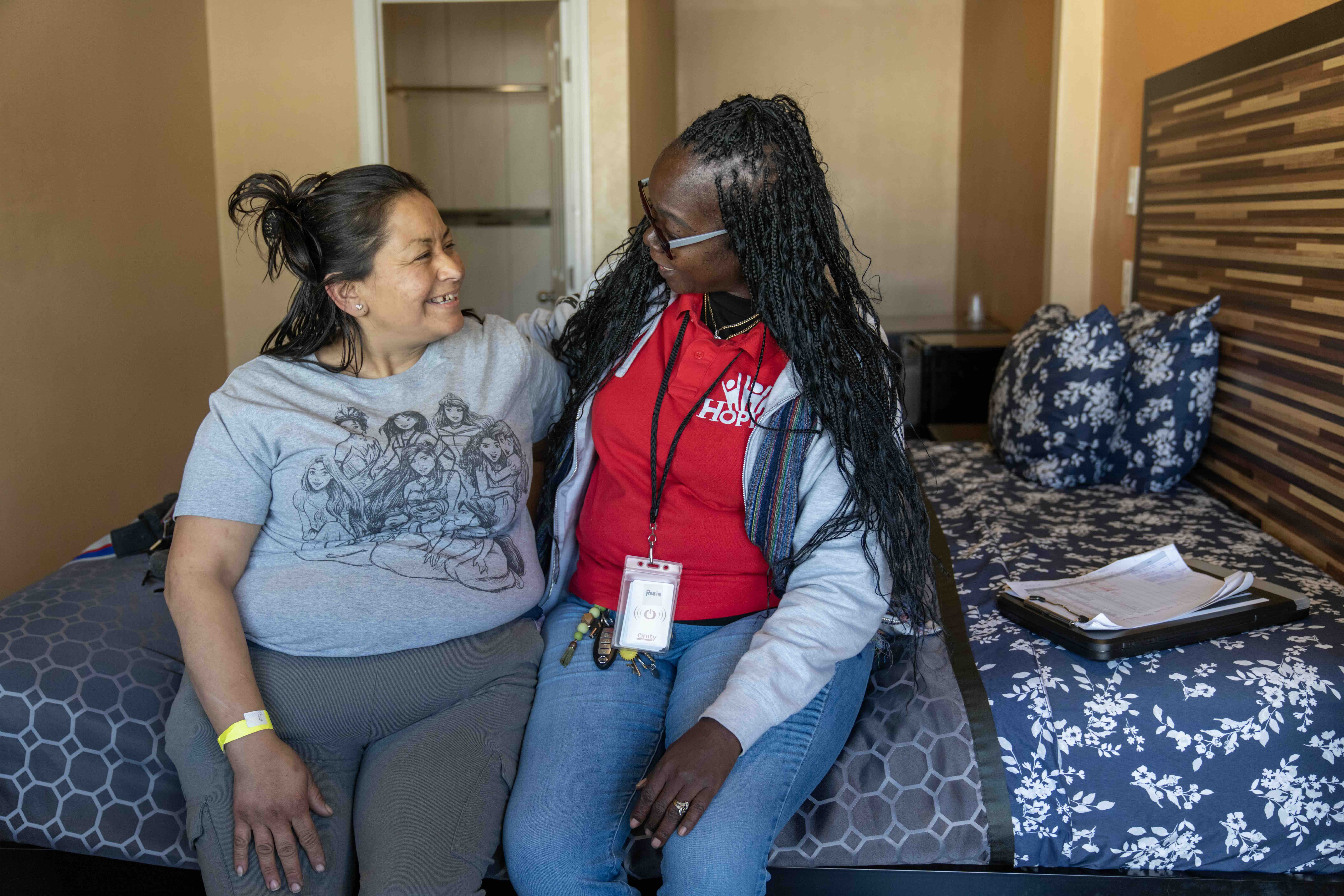 Rosie Atkins with HOPICS, a Pathway Home service provider, left, shows a room to Elsa Jimenez, who had been living under a bridge in Compton until Los Angeles County led a Pathway Home encampment resolution in that community on January 9, 2024. (Mayra Beltran Vasquez / Los Angeles County)