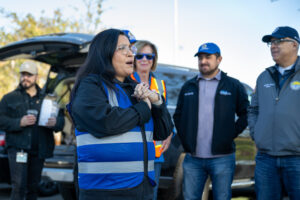 A woman from the Pathway Home team addresses the team before encampment resolution work gets underway at a recent operation.