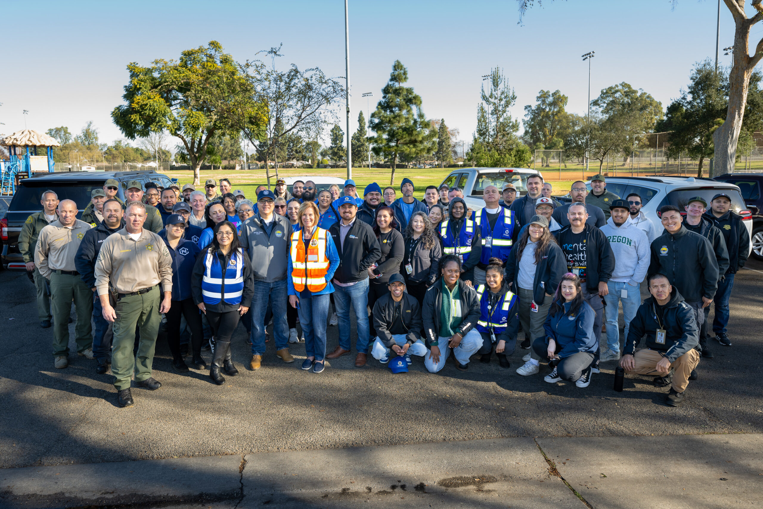 TheLos Angeles county Homeless Initiative Pathway Home Team stands for a group photo before the start of an operation in Downey.