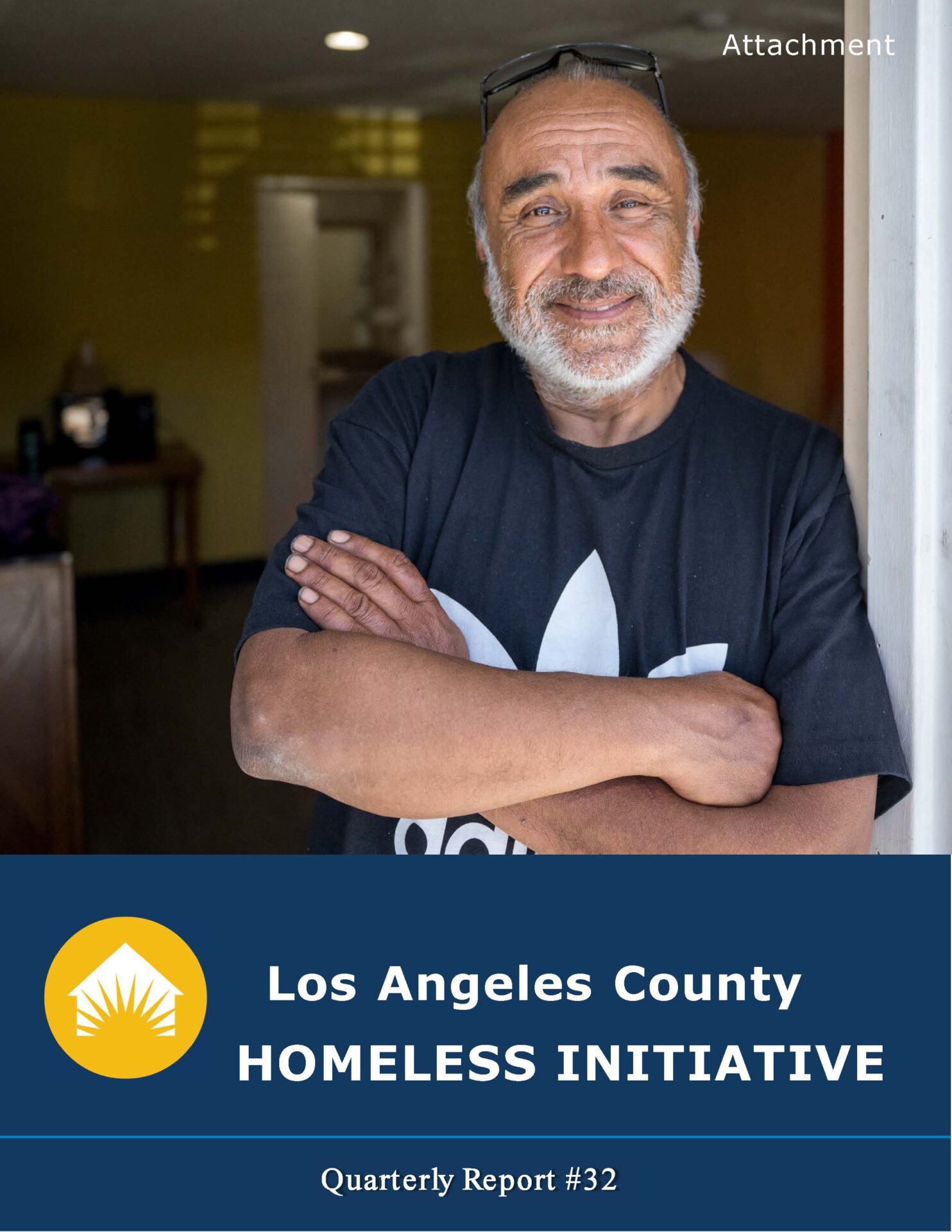 A smiling man stands confidently in a welcoming space, representing hope and support in the fight against homelessness.