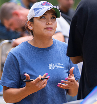 A compassionate outreach worker engages with community members, advocating for homelessness solutions in Los Angeles.