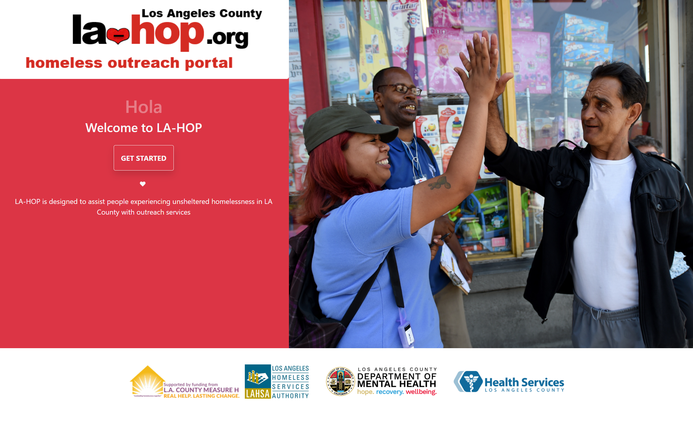 A smiling outreach worker high-fives a man outside a store, embodying community support for those experiencing homelessness.