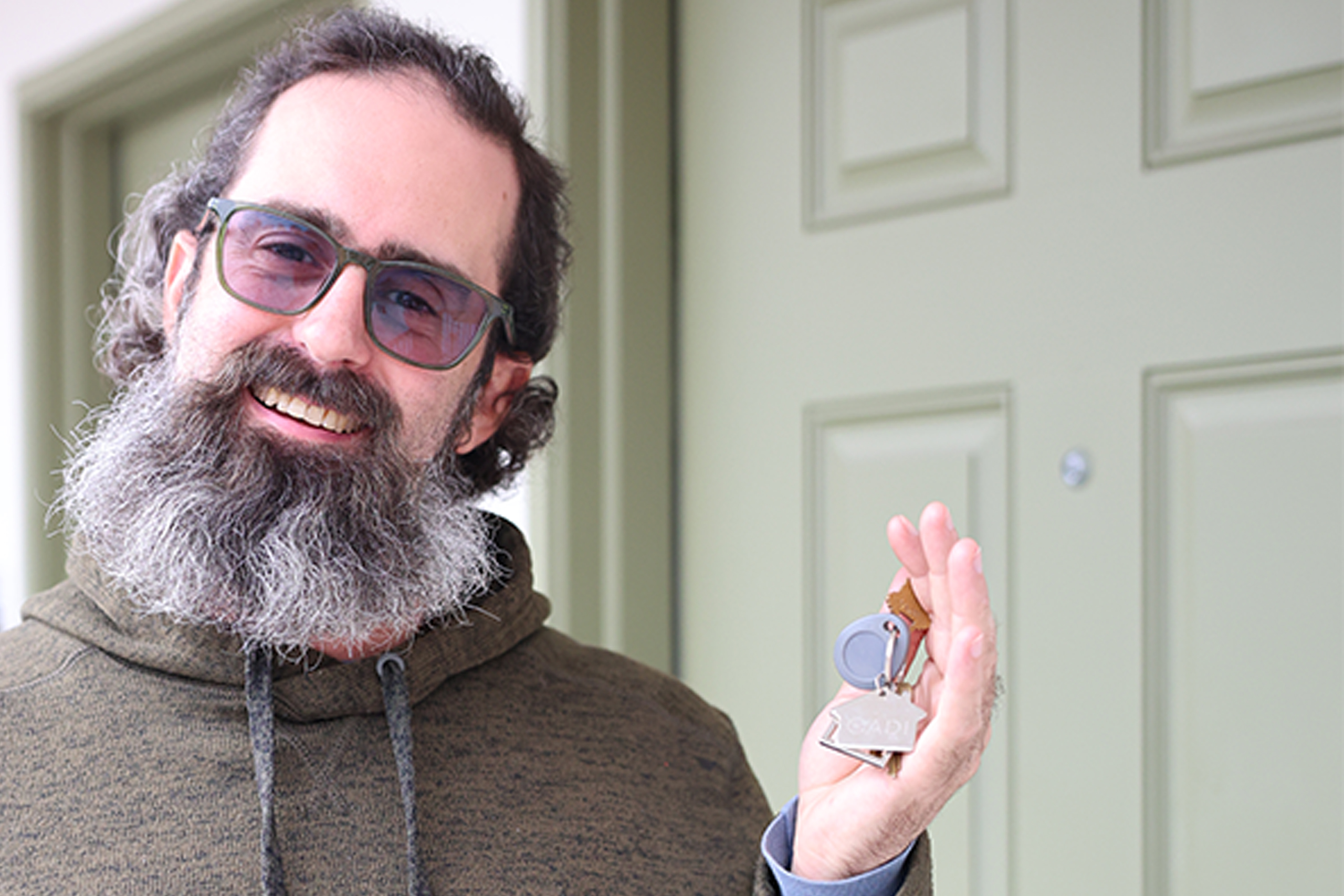 Man holding keys to an apartment.