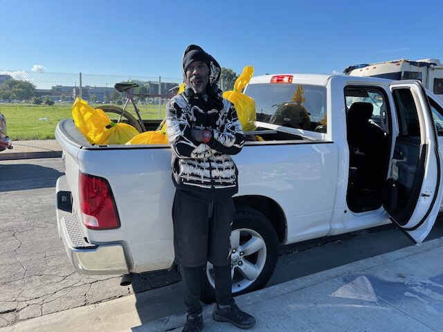 Jerrikk poses with his belongings before heading to the interim housing site.