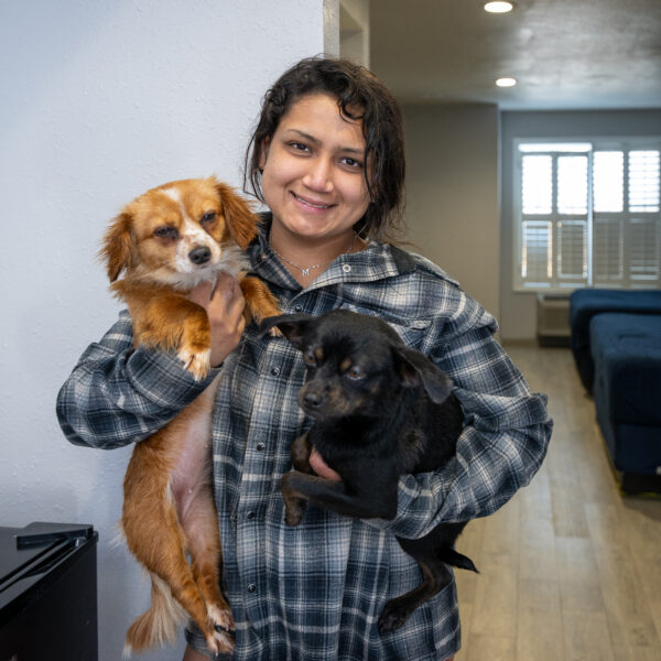 Martha Martinez holds her dogs Princess and Baby in her interim housing in Inglewood during a Pathway Home operation, Wednesday, Feb. 25, 2026. (Photo by Michael Owen Baker)