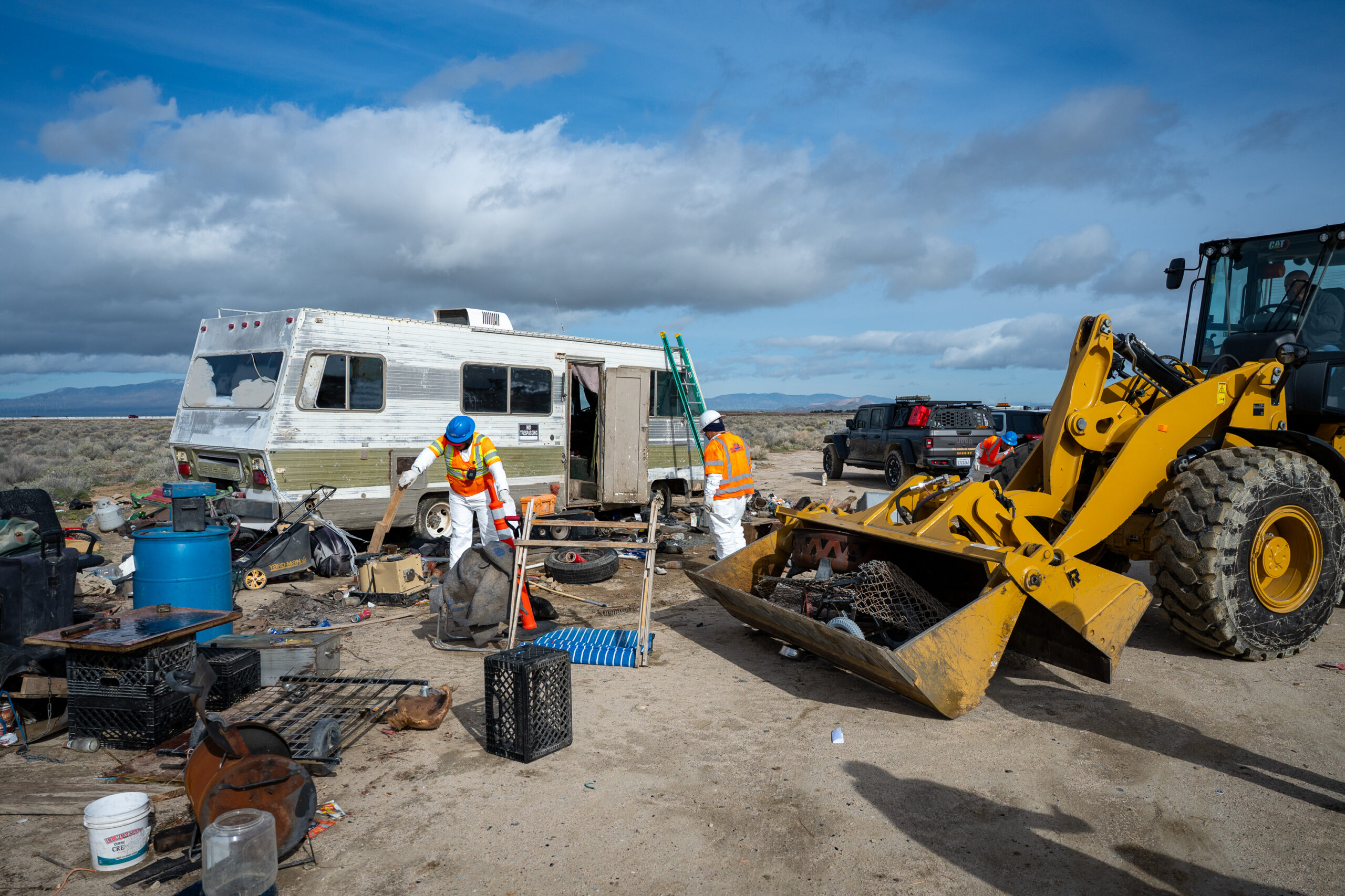 A cleanup crew clears stuff around an RV that was to be towed during a Pathway Home operation in Lancaster, Wednesday, Feb. 11, 2026. (Photo by Michael Owen Baker)