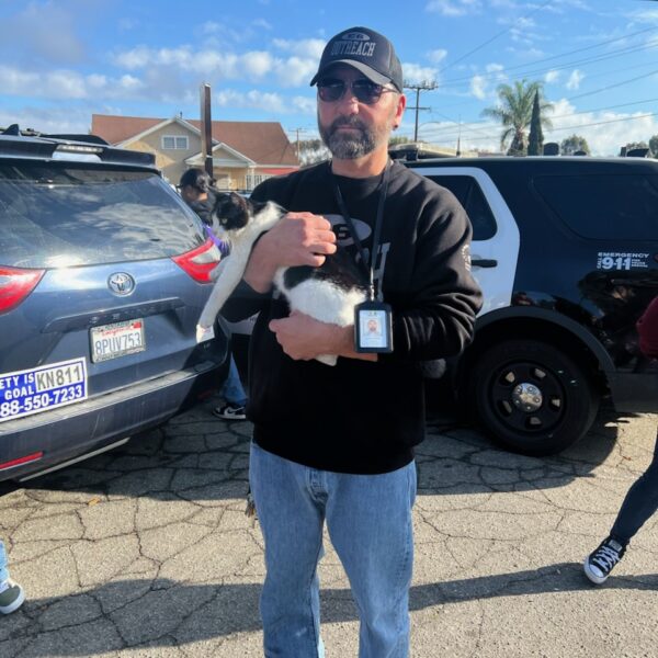 James Foley, an outreach worker with HOPICS, poses with a local cat.