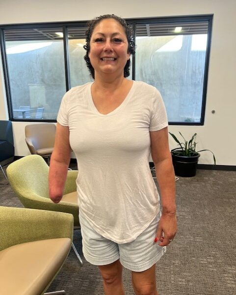 Denise stands in the lobby of her interim housing at Bridge to Home, an interim housing provider in Santa Clarita.