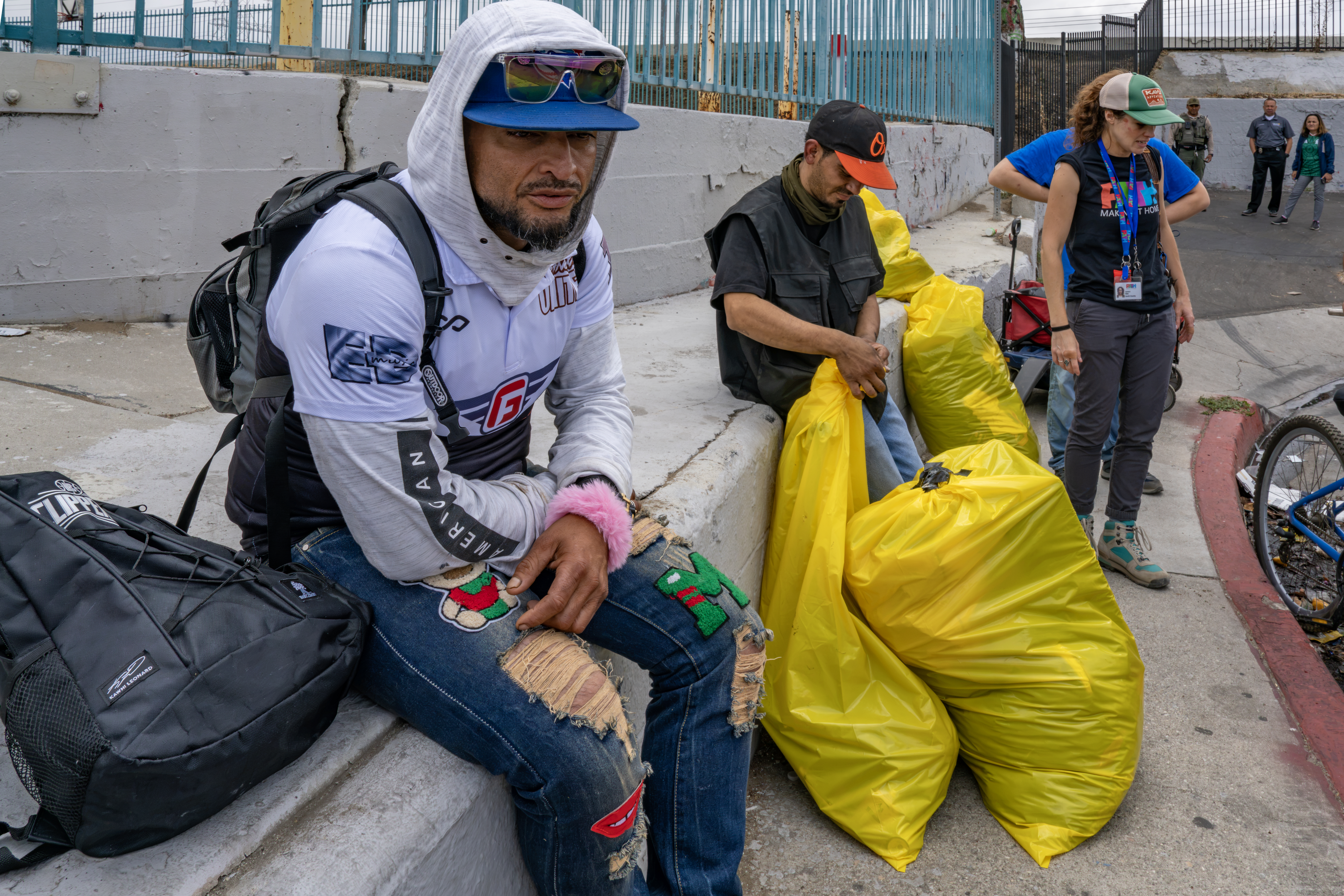 South Gate, CA - June 30: Aunner, 40, left, and Mario, 33, wait for transportation to their new interim housing. (Irfan Khan / Irfan Khan)