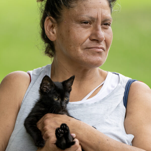 Maywood, CA - June 30: Maria, 55, holding a kitten, waits for her turn to get processed for a motel room. (Irfan Khan / Irfan Khan)